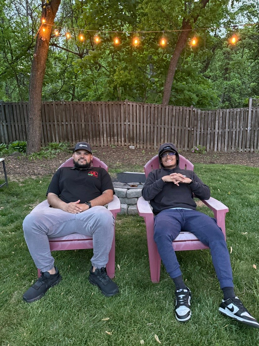 Allan and a client relaxing in a backyard after a shoot